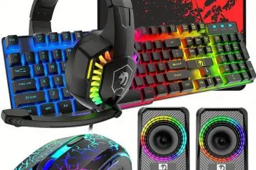 Electronic gaming setup with neon headphones, keyboard, speakers, mouse, and screen